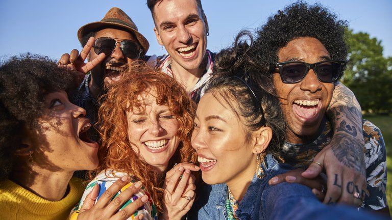 A close-up selfie of a group of friends having fun together.