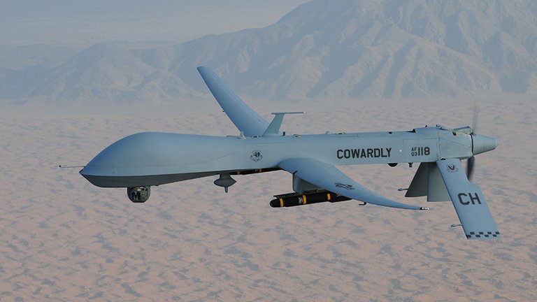 Photograph of drone with "COWARD" written on the side of the drone.