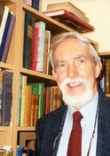 Photo of Anthony Cross FBA standing in front of bookshelves