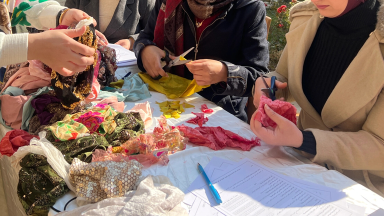 Close up of women doing crafts at a table