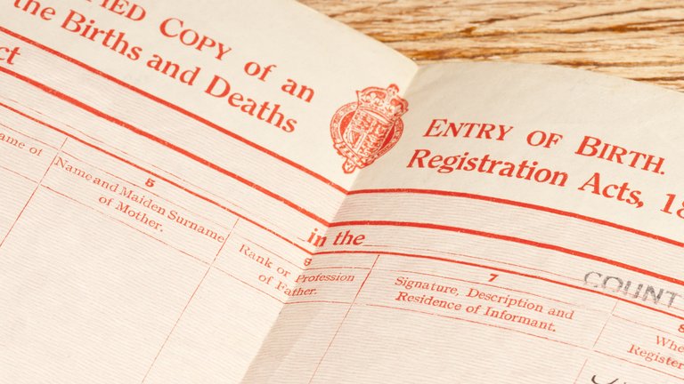 A close-up of the open page of a British birth certificate