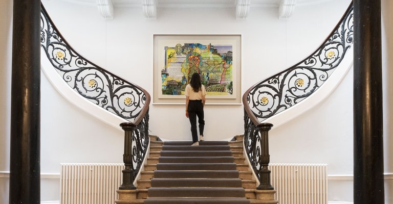 Photograph of the staircase in No.11 featuring Hew Locke painting