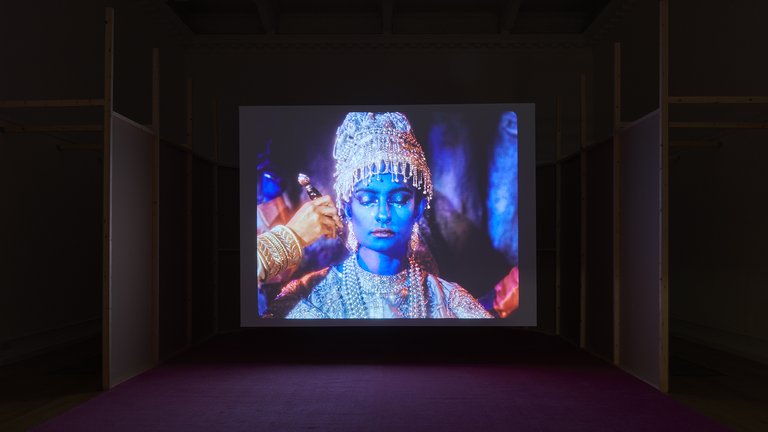 Installation view of colourful short film in an art gallery environment.