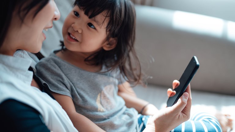 Child looks up and listens to her mother talking.