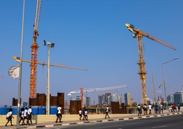 Angolan construction site with several large cranes on the horizon