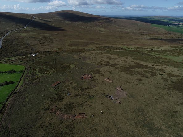Aerial photograph showing the excavation site and the circle of stone holes in a field in Wales.