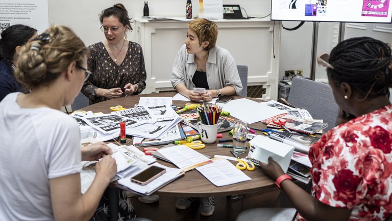 A group of people work together on an art project