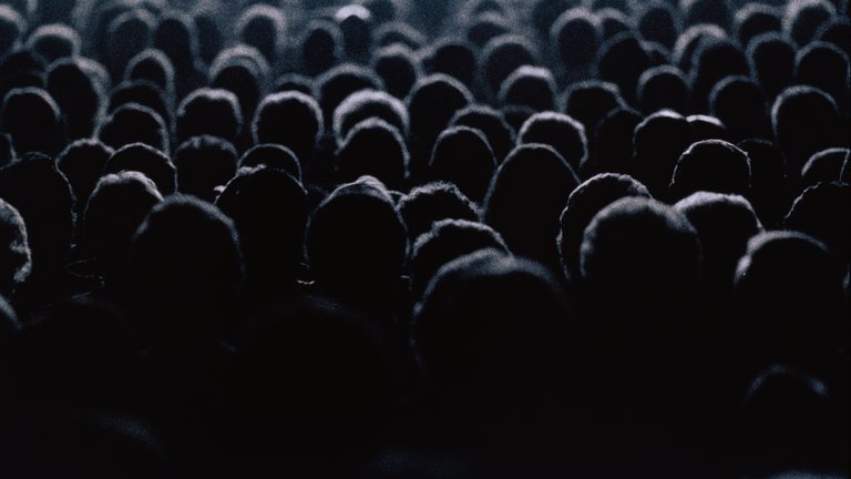 Silhouettes of people in a crowd