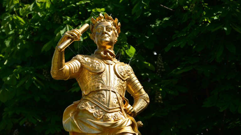 Golden statue in a public plaza of King George II from the 18th century.