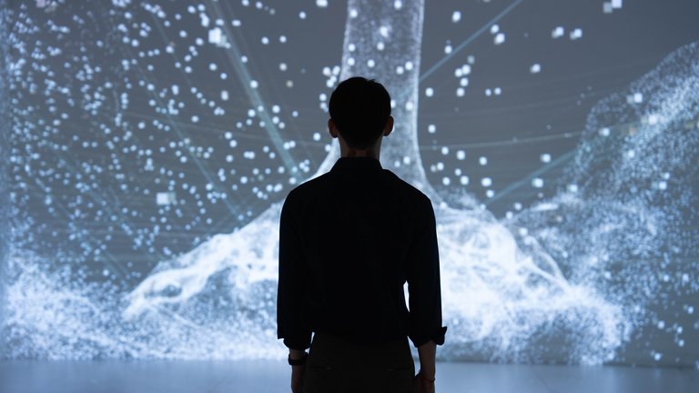 Silhouette of a man looking at a virtual reality background