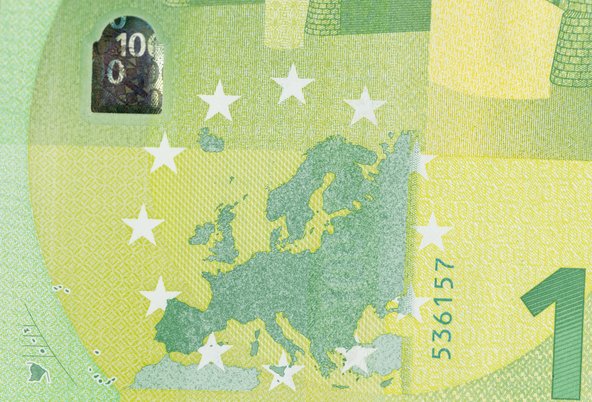 Close-up of a green euro bank note. The side depicting a map is visible. French overseas territories are represented in the bottom left corner.