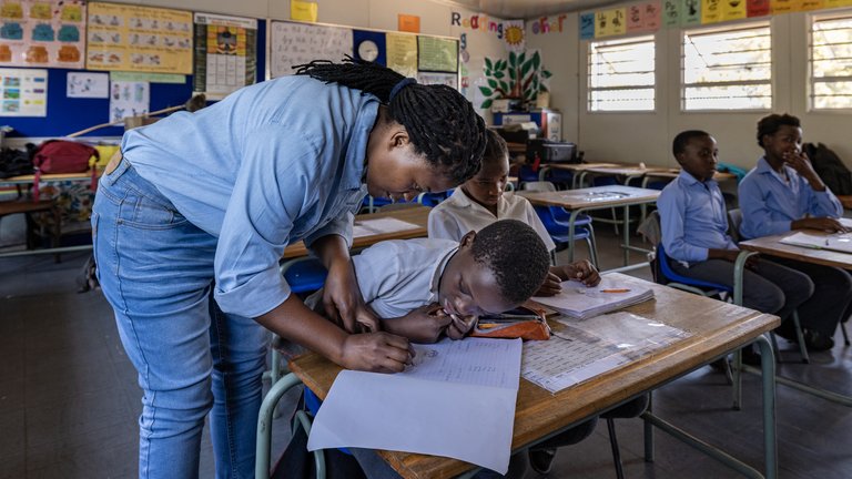 Child being taught by teacher