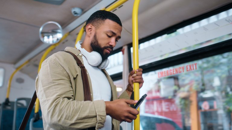 Man with phone for communication, social media or typing email on urban commute.