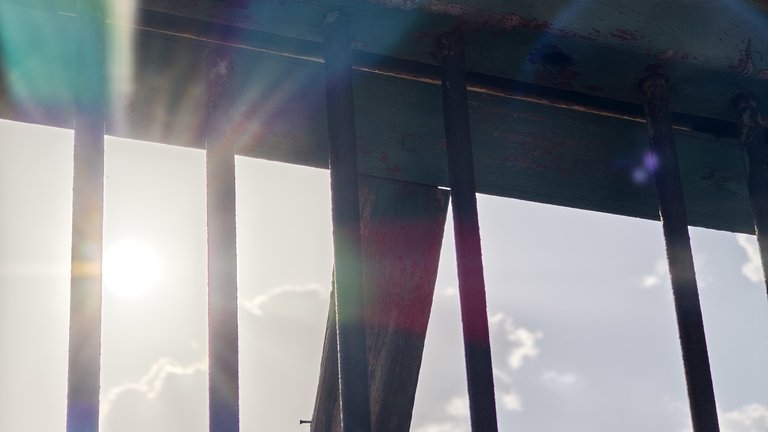 View of sunny sky through prison bars