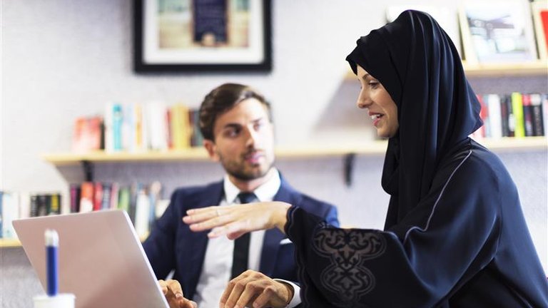 A businesswoman working with her colleague