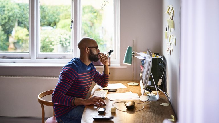 Young person sitting at a desk working from home