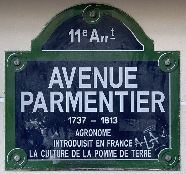A photograph of a Parisian street sign, crediting Parmentier for introducing the potato to France