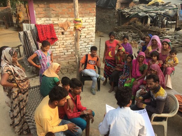 A group of people gathered in a courtyard in India