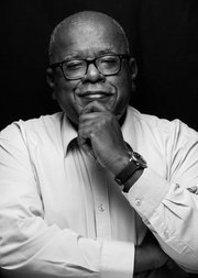 Black and white photo of Jonathan Jansen FBA with his hand on his chin, looking into the camera