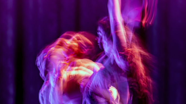 A dynamic image of two people performing together