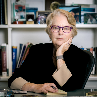 Image of Lynn Hunt looking at the camera while sitting at her desk