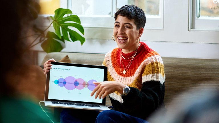 Cheerful young woman with laptop smiling