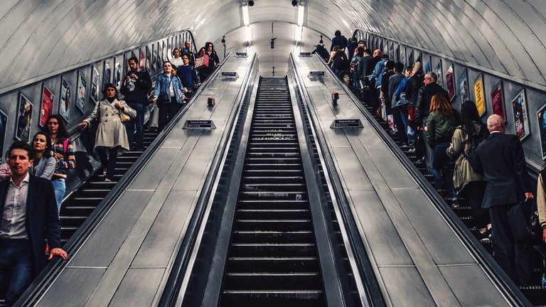 People travelling on escalators at a London Underground station
