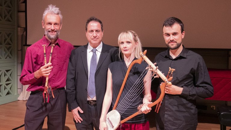 Four musicians holding instruments used in the ancient world