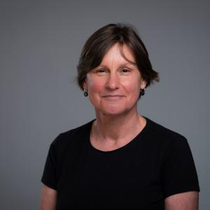 A photo of Miriam Meyerhoff FBA against a dark grey background.
