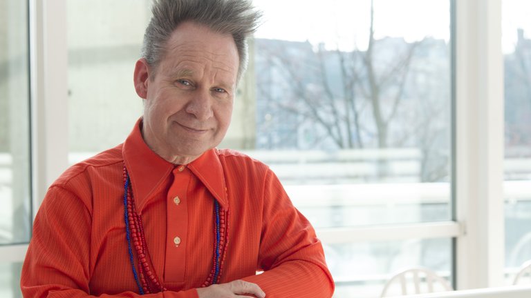 Professor Peter Sellars in a red shirt