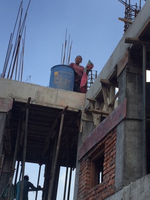 A woman stands on a construction site in Bhaktapur