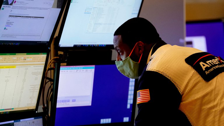 An analyst looks at a wall of screens. TIMOTHY A. CLARY / Contributor via Getty Images