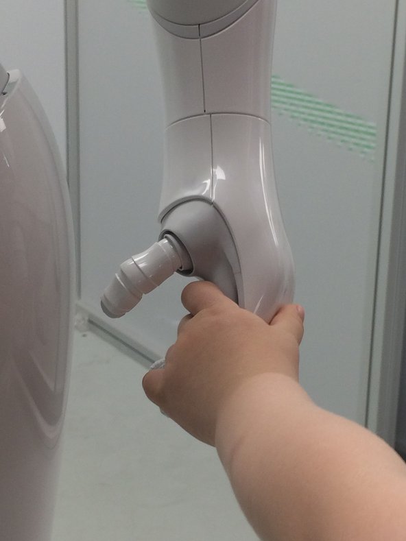 A human hand holds an artificial hand