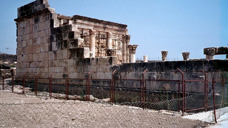 Photograph of ruins of ancient Capernaum synagogue depicting remnants of an ancient building wall