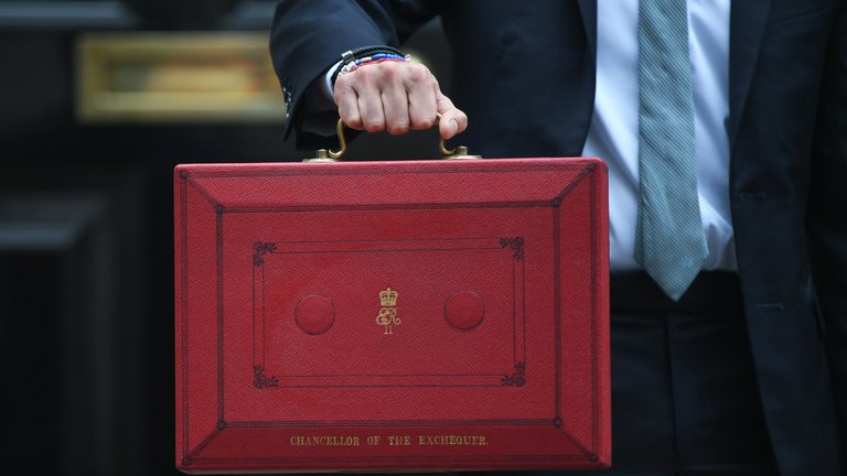 The Chancellor of the Exchequer holding an iconic red briefcase