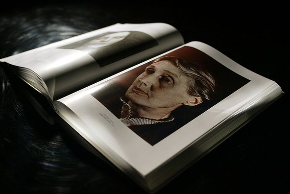 A book called 'Women Seeing Women', open at a page showing a portrait of the writer Virginia Woolf.