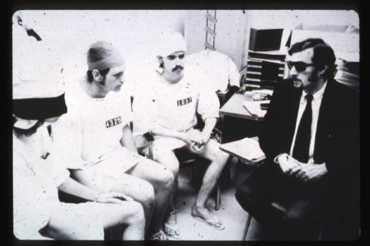 Black and white photograph showing men participating in the Stanford Prison Experiment.