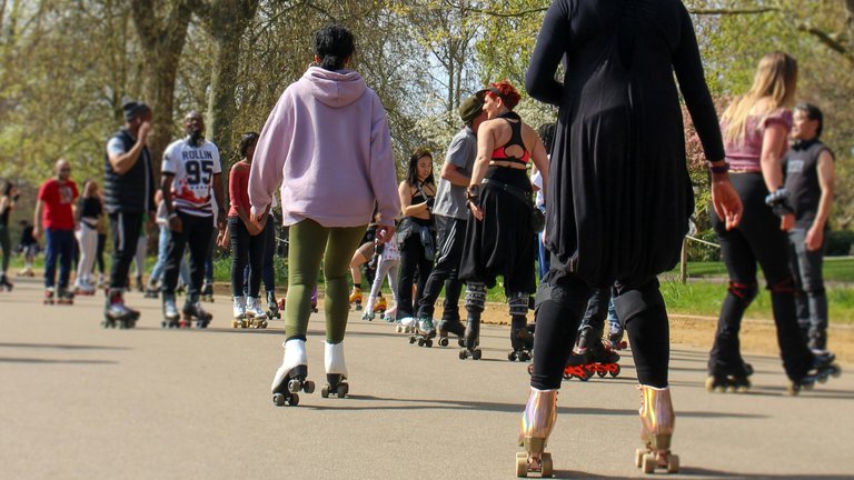 People roller skating in a park