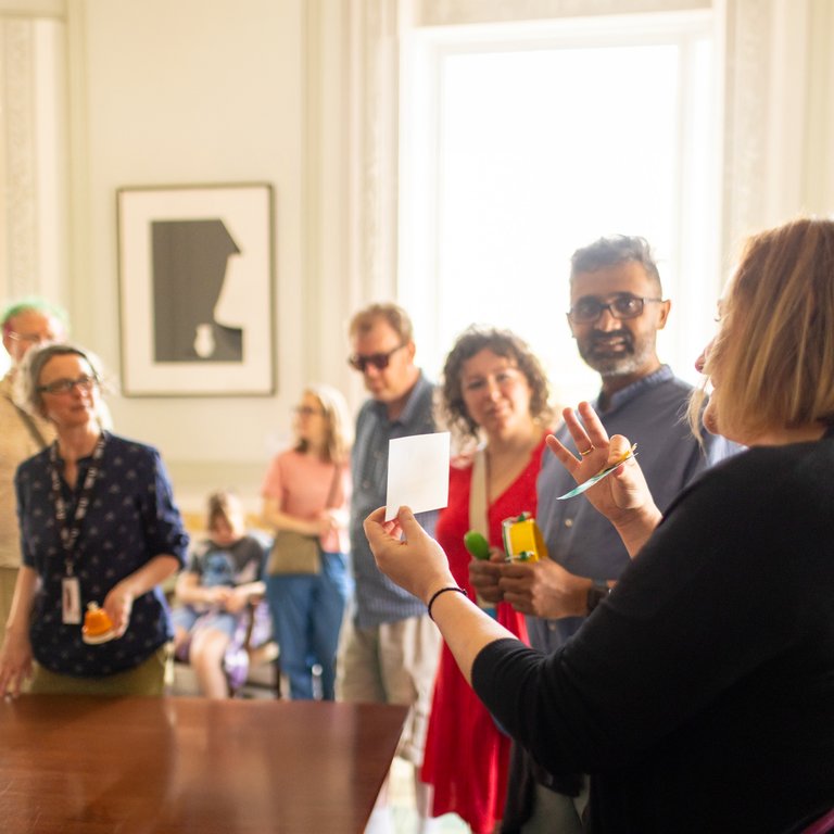 A group of people talking to a researcher at an Academy event