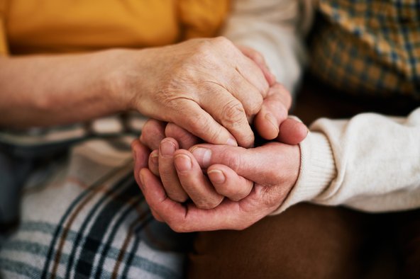 Elderly couple holding hands