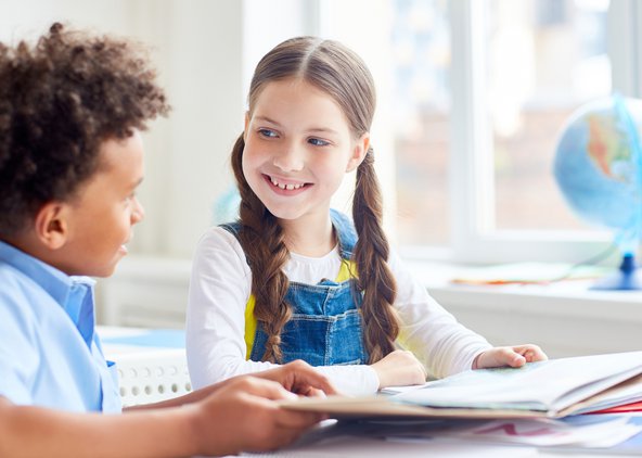 A boy and a girl reading together