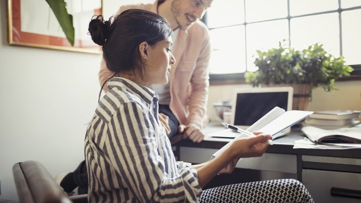 A photo of two researchers reviewing papers