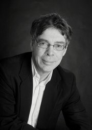 Black and white portrait headshot of Simon Schaffer