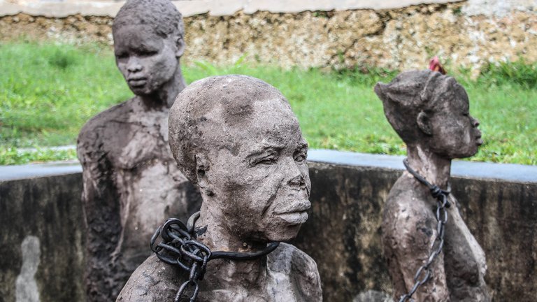 Statues of enslaved people from the old slave market in Stone Town, Zanzibar, Tanzania.